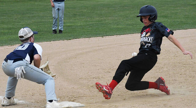 With the ball coming in just off his right hip, Wesley Yaczik, right, of the Mt. Orab Diamondbacks beats the throw to third base during an East Region Knothole Baseball Class B Senior playoff game June 29, 2023, at Finley Ray Park in Milford.