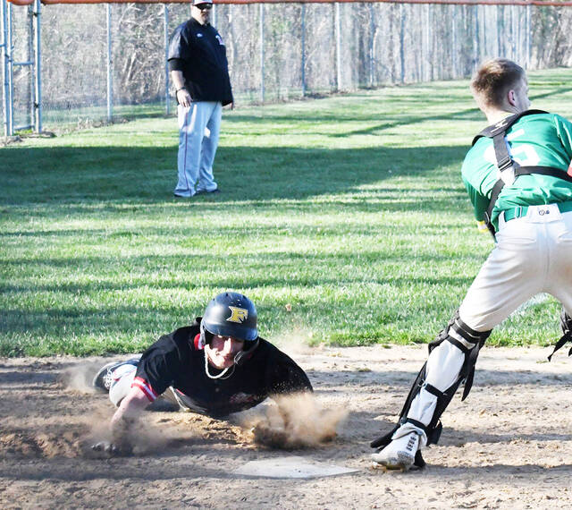 Wyatt Haupt – shown here diving into home plate to score a run this past season – and his Eastern Brown High School Warriors led a contingent of area Brown County teams that reached heights not seen in years.