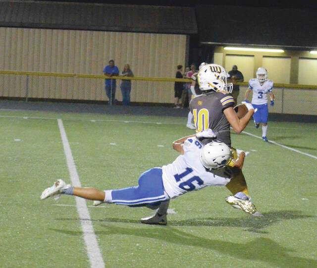 Western Browns Isaiah Smith breaks a tackle on his way to the end zone during the Broncos week two game against Washington Courthouse. Photo by Wade Linville