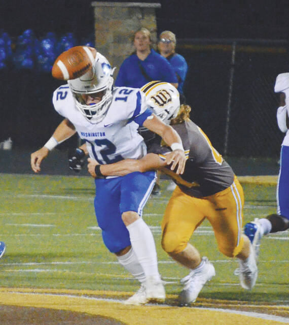 Western Browns senior linebacker, Vincent Mickles, forces a fumble in the Broncos week two game against Washington Courthouse. Photo by Wade Linville