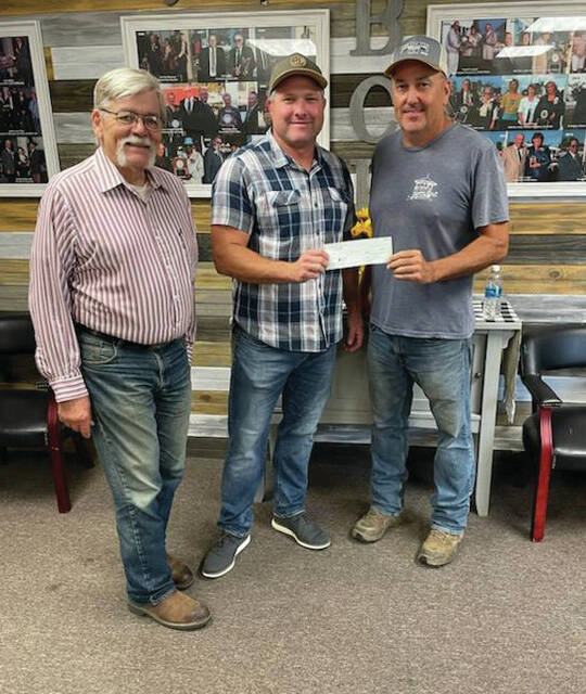 Tim OHara, of LaRosas and Dunkin Donuts of Mt. Orab (center), presents a $20,000 check to David Frye, of the Brown County Fair Board, while Tim McKeown of the Brown County Horsemans Association looks on. OHara also pledged an additional $50,000.