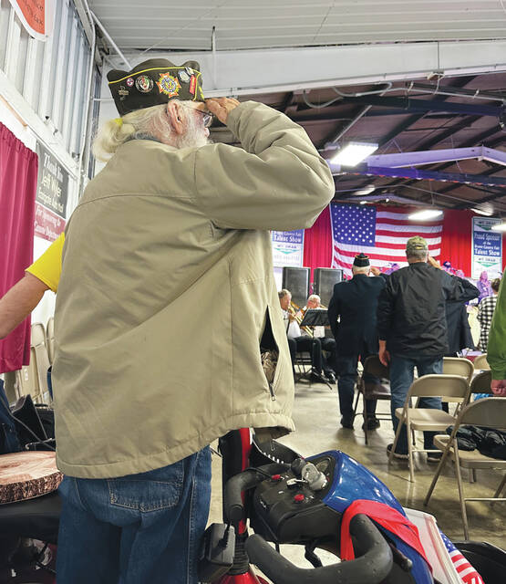 Standing to salute during the Brown County Fair Veterans Recognition Service held Sept. 28. Photo by Wade Linville