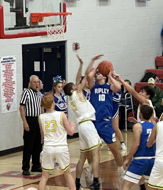Ripley sophomore Blake Fyffe muscles up a shot while being fouled by West Union defenders during the Southern Hills Athletic Conference Boys Basketball Preview held Nov. 24. Fyffe led the Jays in the half-game preview with 14 points. Photo by Wade Linville