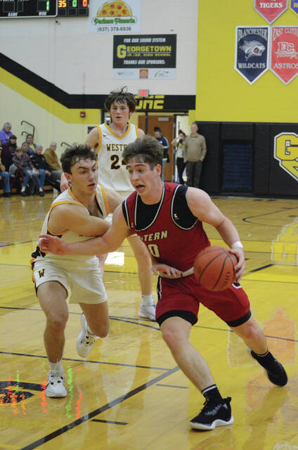 Easterns Wyatt Haupt drives to the hoop while guarded by Western Browns Abe Crall during the Brown County Holiday Tournament championship game on Dec. 29. Photo by Wade Linville