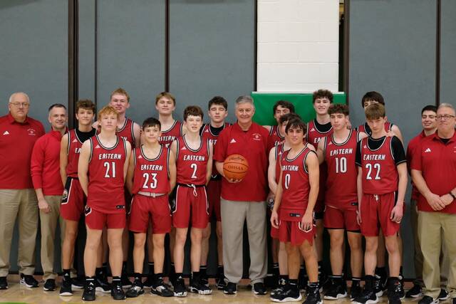 Eastern High School varsity boys basketball coach, Rob Beucler, with his Warriors after recording his 450th career win. Photo courtesy of Amanda Reed Lynch.