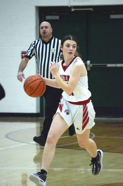 Eastern junior Lilly Yuppa shot for 11 points to lead the way in scoring for the Lady Warriors in their sectional tourney win over West Union, Feb. 12. Above, Yuppa heads down the court on a fast break during a game this season. Photo by Wade Linville