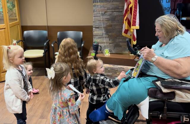 Local children enjoyed spending time with residents of the Ohio Veterans Home in Georgetown during the initial Book Battalion book reading event held Feb. 29. Photo by Wade Linville