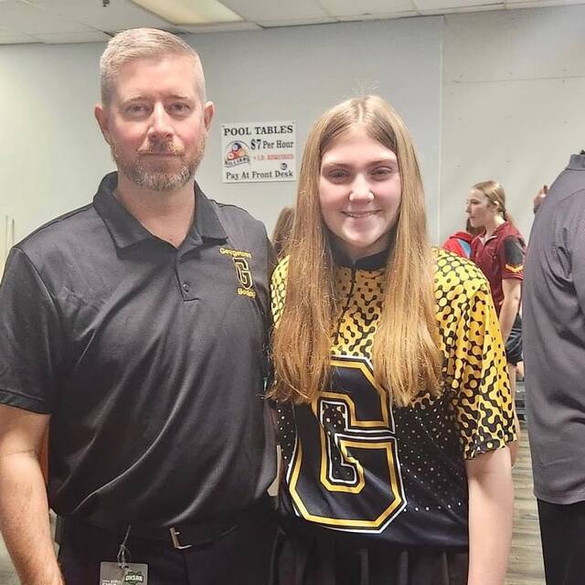 Georgetown High Schools sophomore bowling standout, Carolyn Edmisten, recently competed in the OHSAA Division II Girls State Bowling Tournament in Columbus. Edmisten (right) has been named the Southern Buckeye Athletic/Academic Conference Girls Bowler of the Year, and Georgetowns Brandon Winterod (left) has been named the SBAAC National Division Girls Bowling Coach of the Year. Photo provided