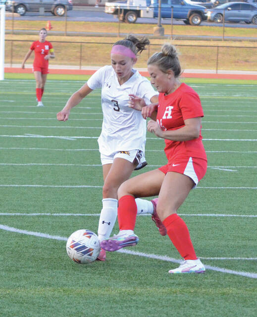 Western Browns Harper Jones battles for possession with a Hillsboro defender. Photo by Wade Linville