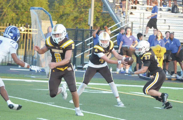 Western Browns Rylin Anderson takes a hand-off from quarterback Brody Barber during the Broncos week three game against Chillicothe. Photo by Wade Linville